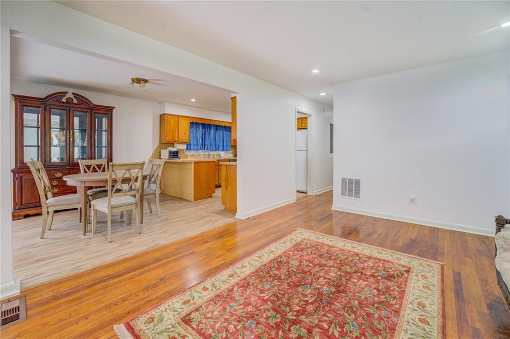 2194 Klondike Road Southwest Conyers, GA 30094 - Photo 8 of 30 a living room with a wooden floor and a dining table with wooden floor
