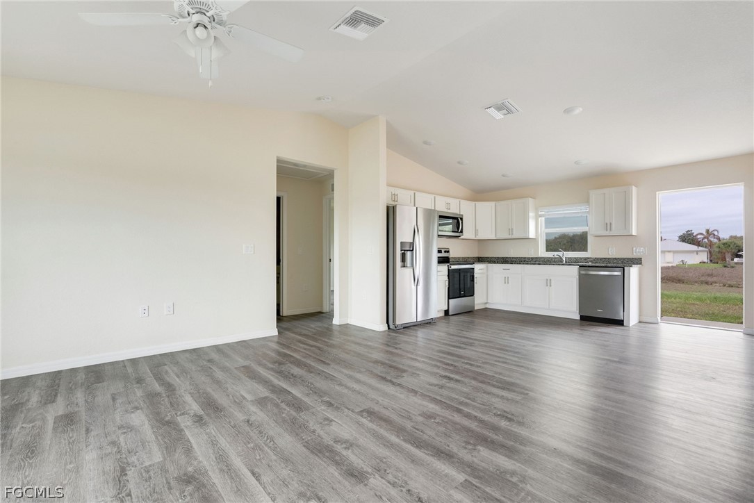 1405 Inwood Road LaBelle, FL 33935 - Photo 7 of 35 a view of a kitchen with a sink a refrigerator and a stove top oven