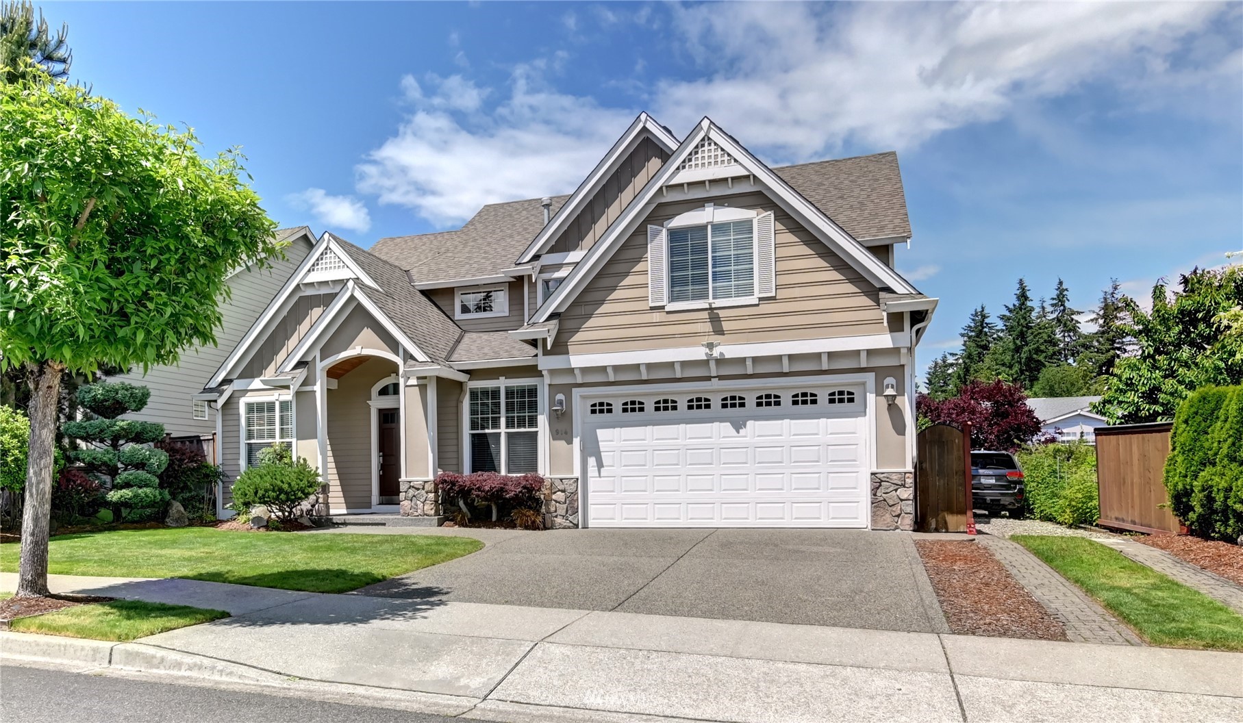 a front view of a house with a yard and garage