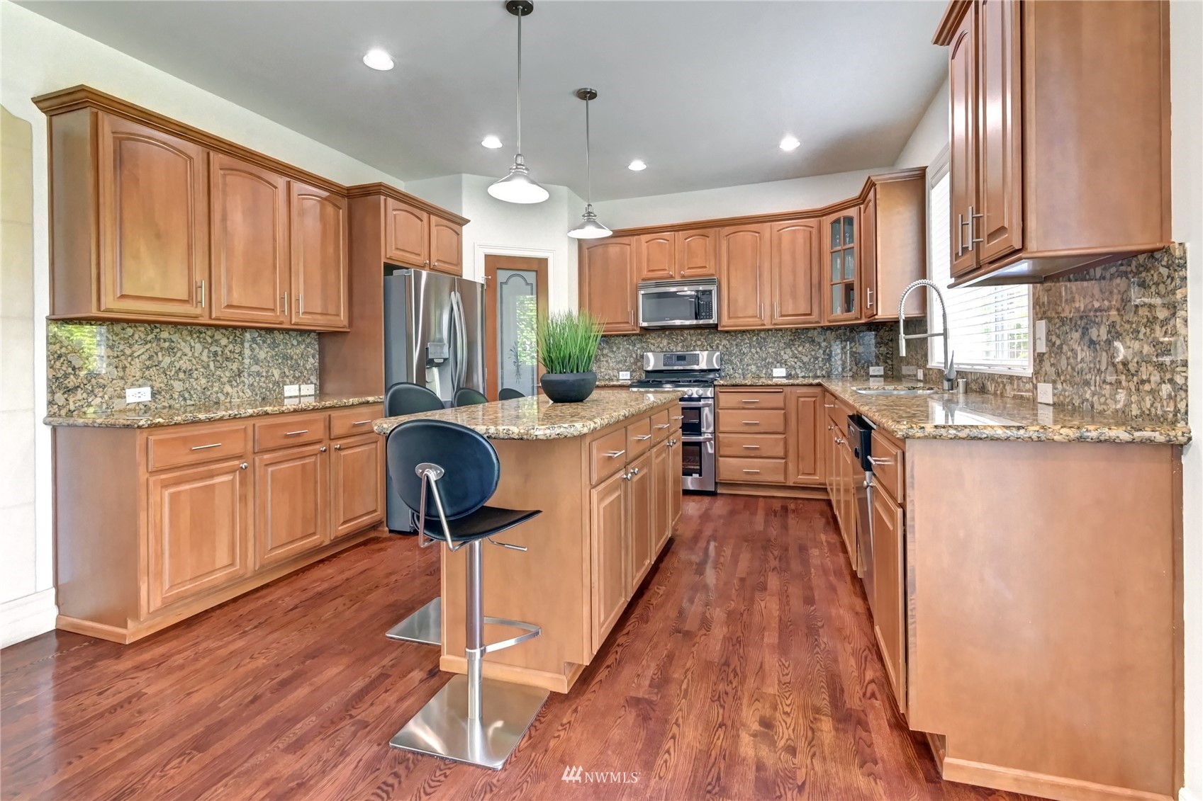 914 Southwest 361st Street Federal Way, WA 98023 - Photo 13 of 40 a kitchen with kitchen island granite countertop a sink a counter top space appliances and cabinets