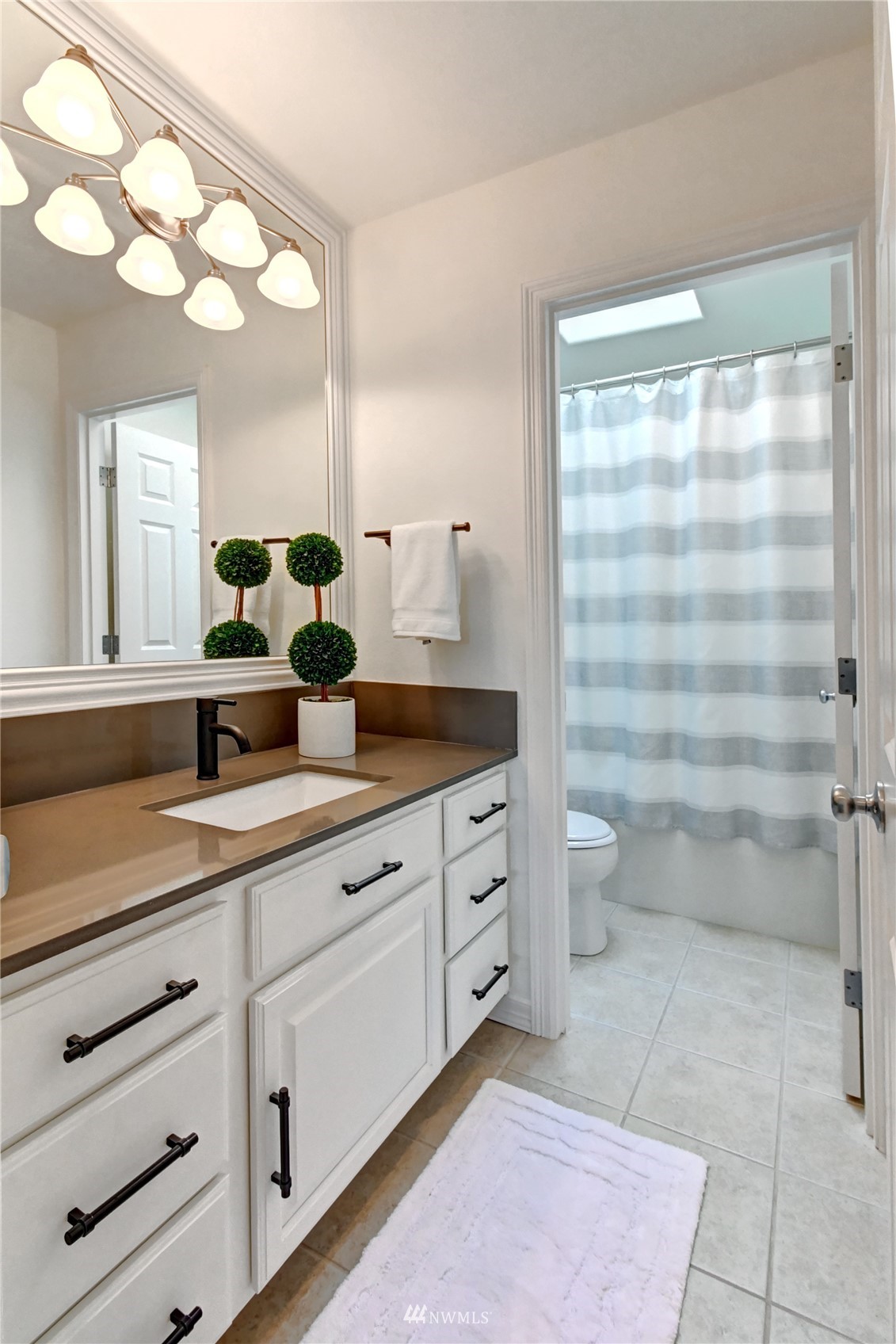 914 Southwest 361st Street Federal Way, WA 98023 - Photo 28 of 40 a bathroom with a double vanity sink a toilet and a mirror