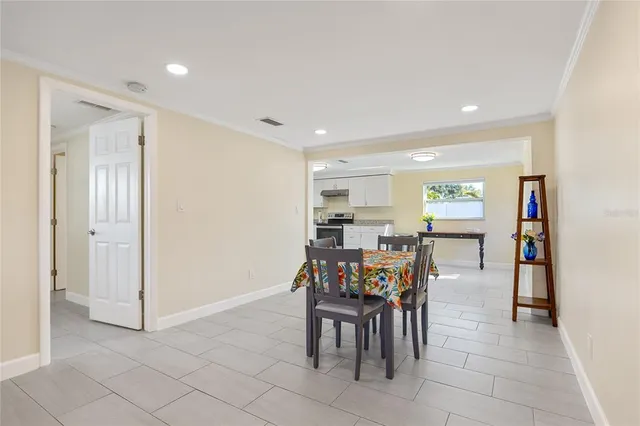 a kitchen with granite countertop white cabinets and stainless steel appliances