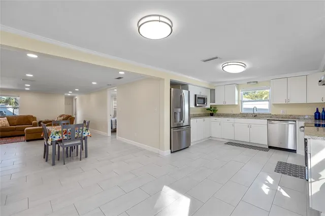 a kitchen with furniture and a refrigerator
