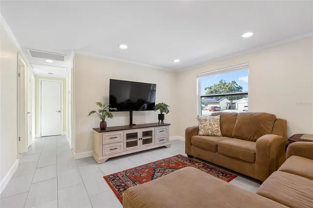 a living room with furniture and kitchen view