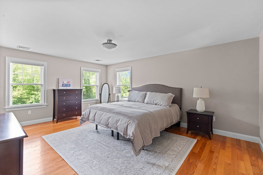 5 Clinton Drive Rehoboth, MA 02769 - Photo 13 of 37 a spacious bedroom with a bed and a dresser next to a window