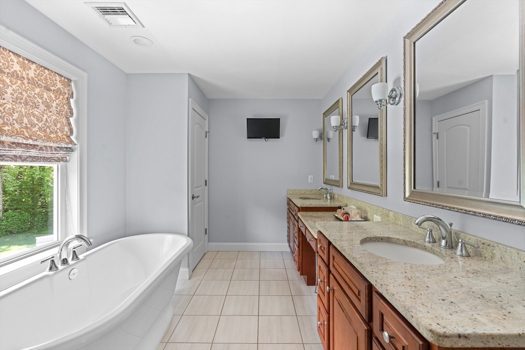 5 Clinton Drive Rehoboth, MA 02769 - Photo 16 of 37 a bathroom with a granite countertop sink and a bathtub
