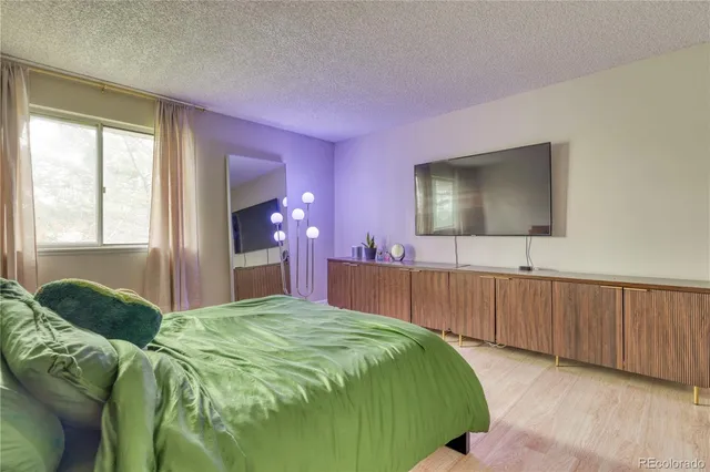 a bedroom with a bed and a flat screen tv