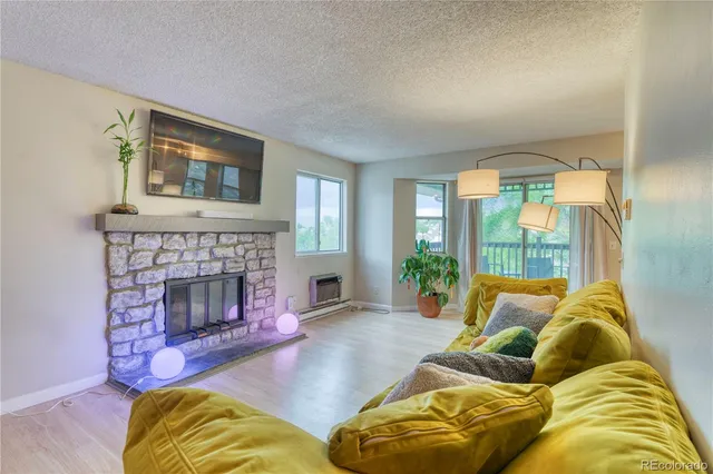 a living room with furniture and a fireplace
