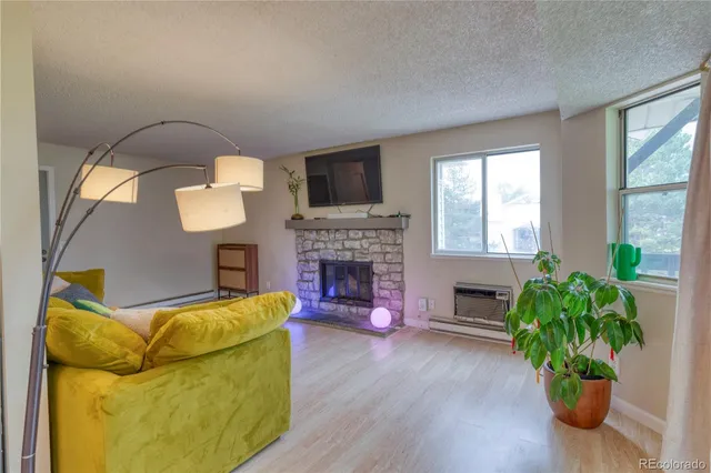 a living room with furniture and a fireplace