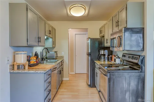 a kitchen with stainless steel appliances granite countertop a stove a sink dishwasher and a refrigerator