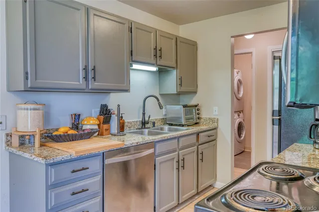a kitchen with stainless steel appliances granite countertop a sink stove and cabinets