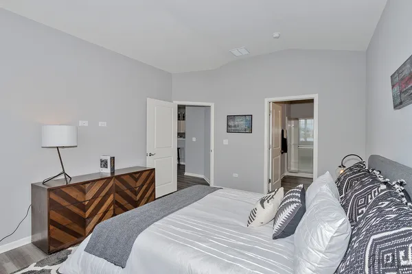 a bedroom with a bed and a lamp