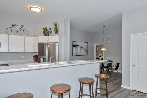 a kitchen with a sink cabinets and wooden floor
