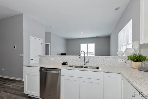 a kitchen with a sink stove and cabinets
