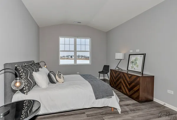 a bedroom with bed and a night stand