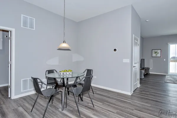 a view of a dining room with furniture and wooden floor