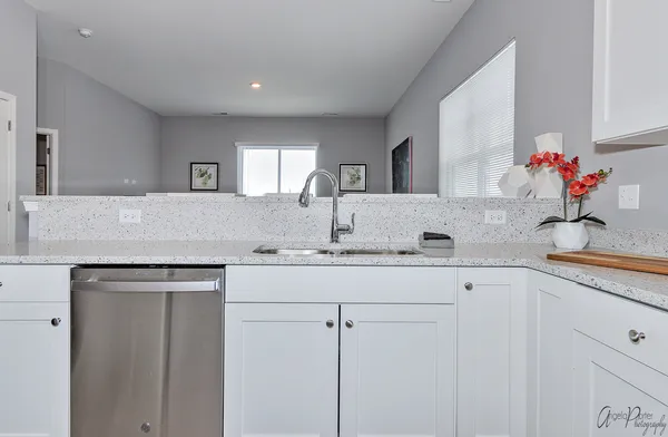 a kitchen with cabinets appliances and a sink