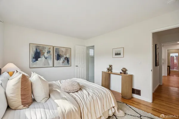 a bedroom with two beds and a large window