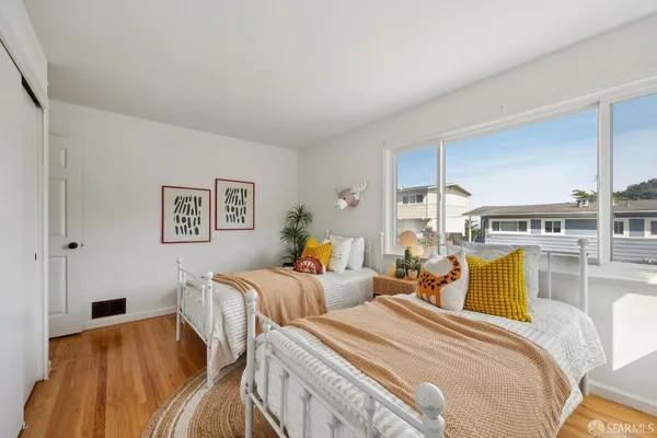 a bedroom with a bed and a potted plant