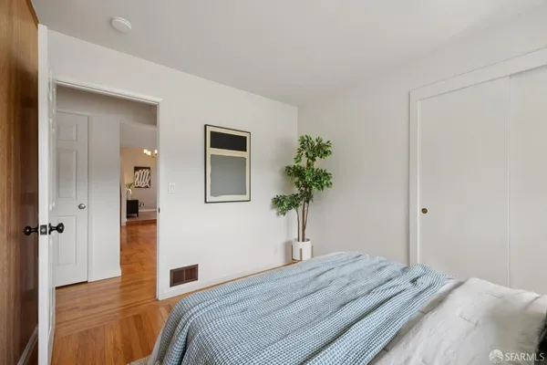 a living room with furniture a potted plant and a lamp