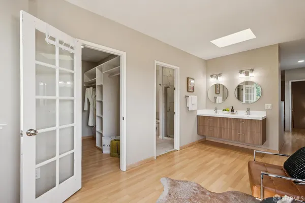 a bedroom with a large bed and a window