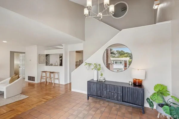 a living room with furniture and a potted plant