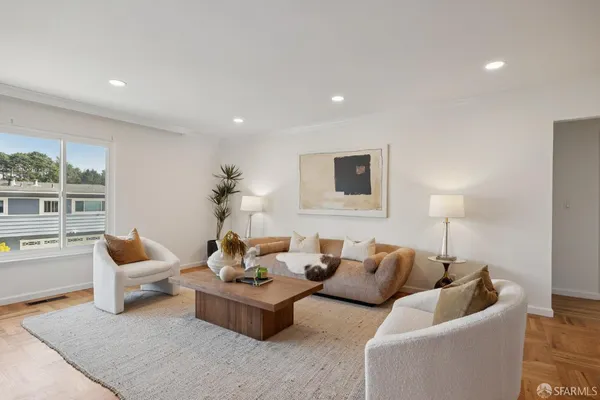 a living room with furniture and a lamp