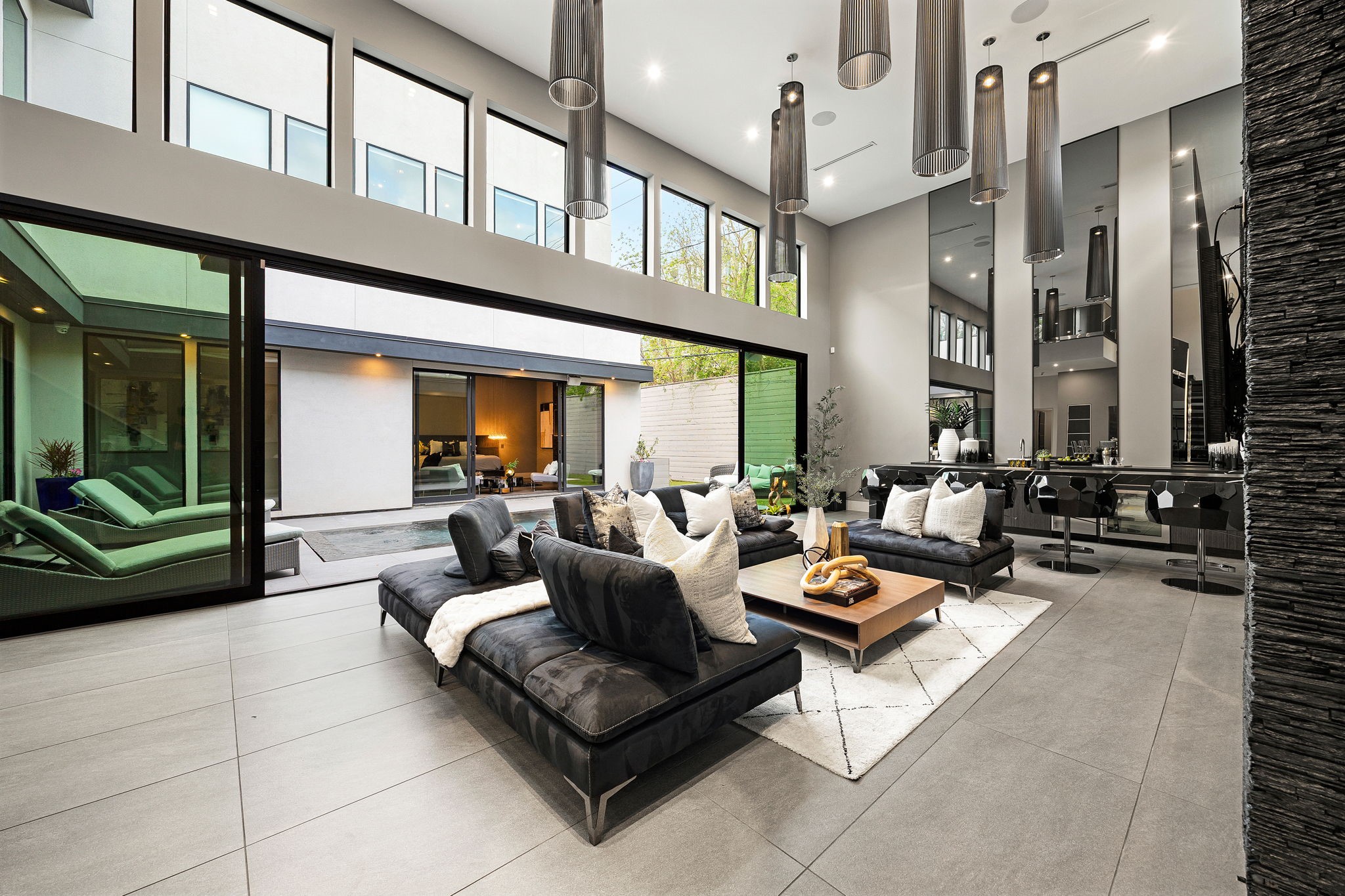 2302 Suffolk Drive Houston, TX 77027 - Photo 4 of 44 Stunning 18-foot soaring ceilings create an expansive sense of grandeur, allowing an abundance of natural light to showcase the home's modern architectural lines