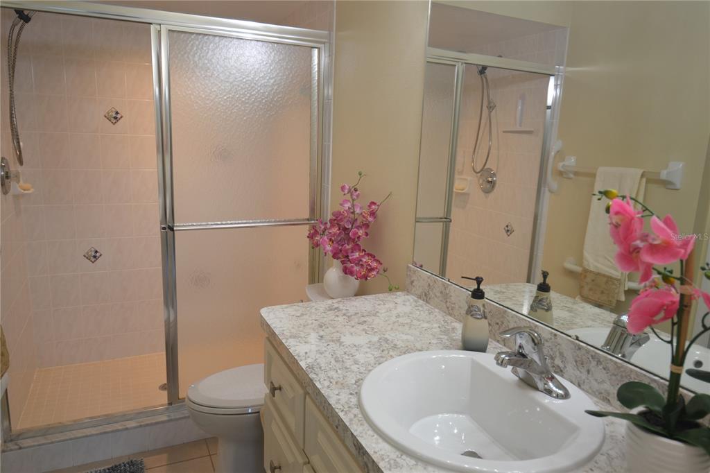 4020 Casa Del Sol Way New Port Richey, FL 34655 - Photo 37 of 98 a bathroom with a granite countertop shower sink vanity and toilet