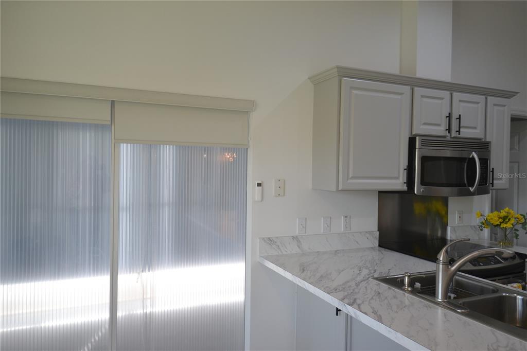 4020 Casa Del Sol Way New Port Richey, FL 34655 - Photo 4 of 98 a kitchen with stainless steel appliances granite countertop a sink a stove and a refrigerator