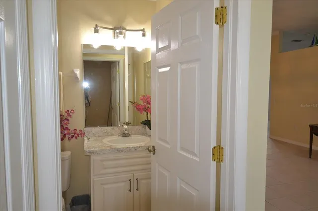 a kitchen with stainless steel appliances granite countertop a refrigerator a stove and a sink