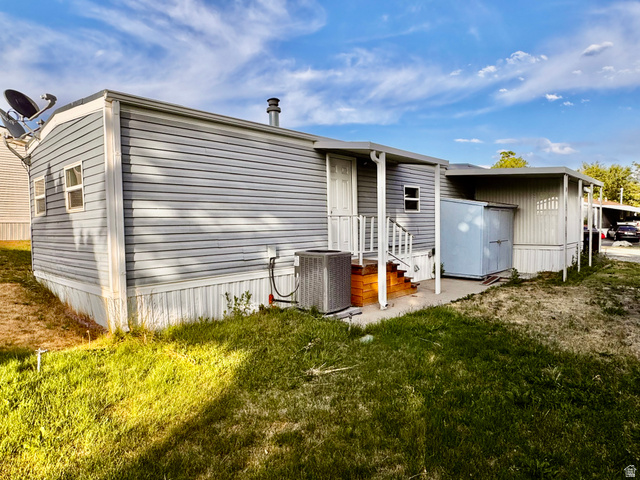 158 Cushing Way Layton, UT 84041 - Photo 13 of 14 Exterior siding with a white trim, a covered porch, and an attached storage shed