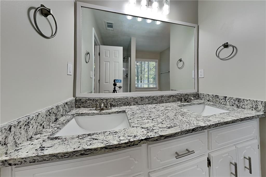 204 Leighs Grove Court Grayson, GA 30017 - Photo 12 of 23 a bathroom with a granite countertop sink and a mirror