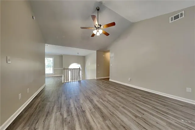 a view of empty room with wooden floor
