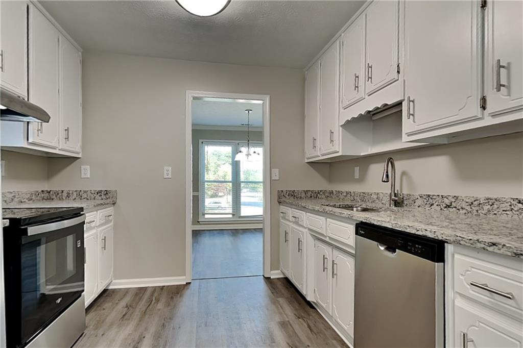 204 Leighs Grove Court Grayson, GA 30017 - Photo 7 of 23 a kitchen with stainless steel appliances granite countertop a stove a sink and a refrigerator