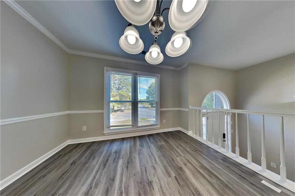 204 Leighs Grove Court Grayson, GA 30017 - Photo 8 of 23 an empty room with wooden floor and windows