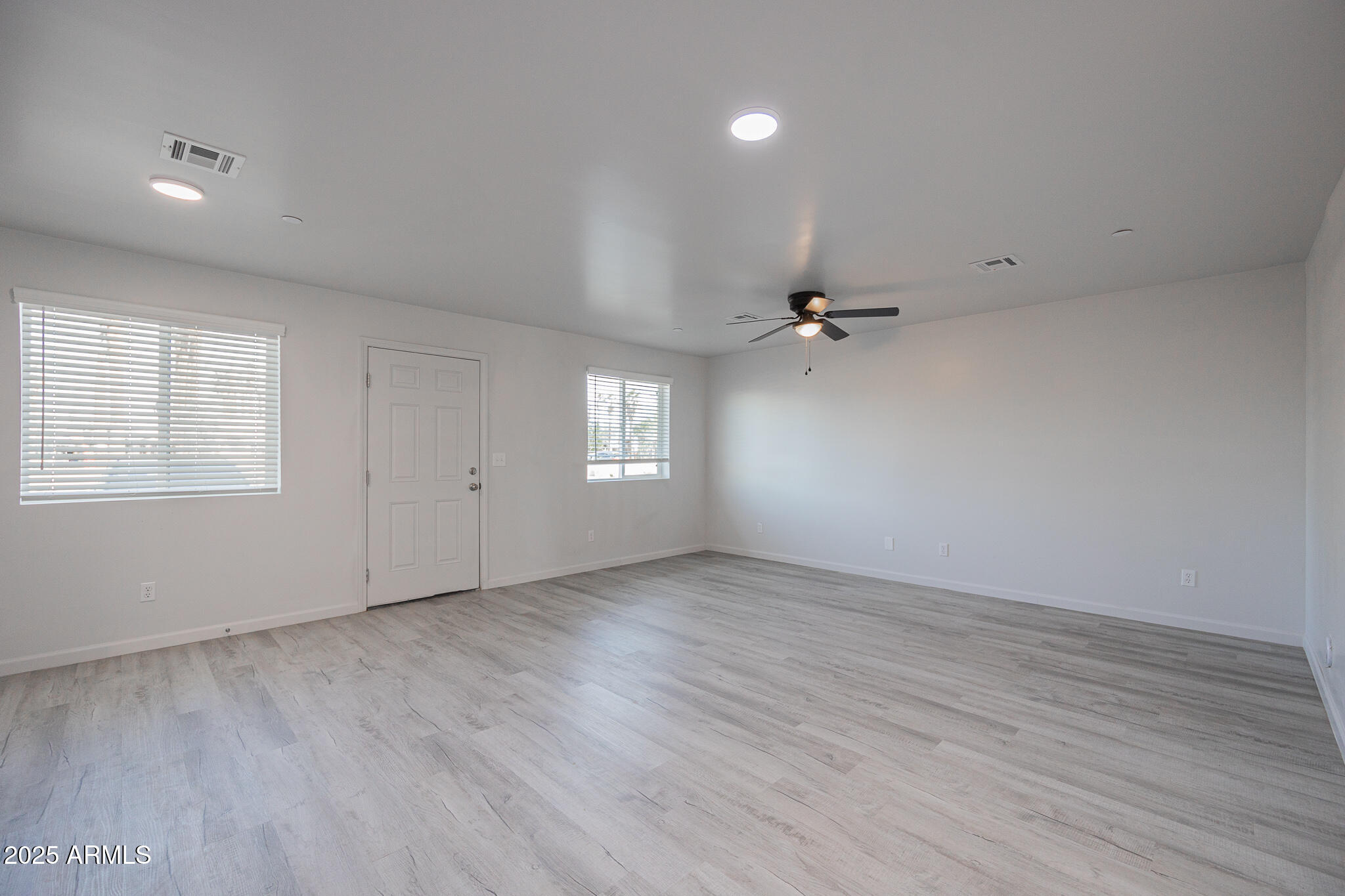 2121 West Adams Street, Unit B102 Phoenix, AZ 85009 - Photo 14 of 25 wooden floor in an empty room with a window