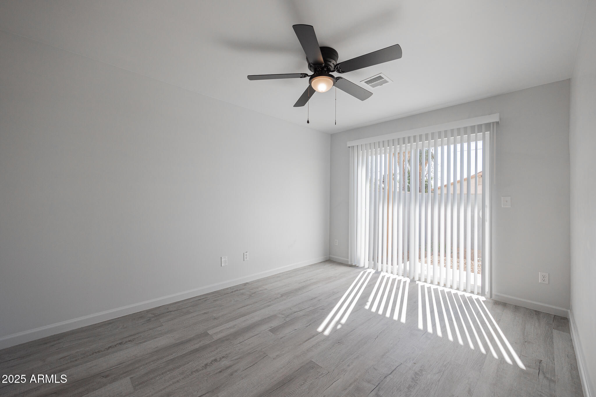 2121 West Adams Street, Unit B102 Phoenix, AZ 85009 - Photo 15 of 25 wooden floor in an empty room with a window