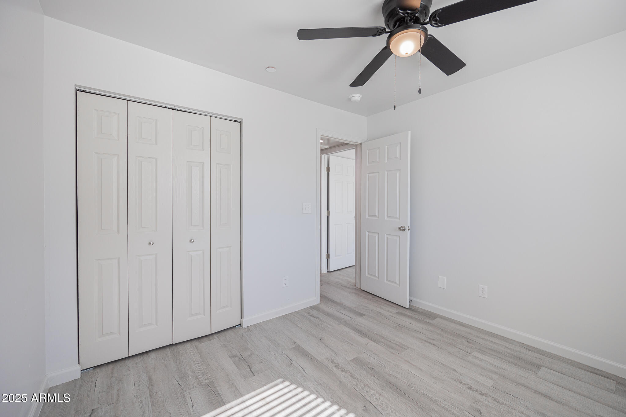 2121 West Adams Street, Unit B102 Phoenix, AZ 85009 - Photo 20 of 25 a view of empty room with wooden floor and fan