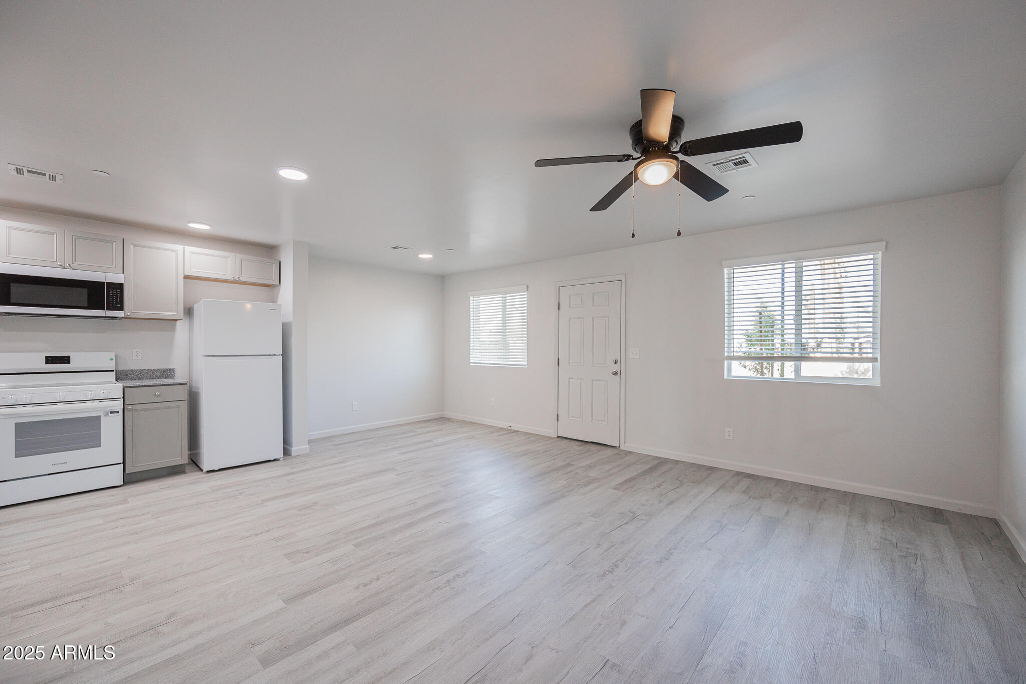 2121 West Adams Street, Unit B102 Phoenix, AZ 85009 - Photo 10 of 25 a view of a kitchen with a sink stove refrigerator and cabinets