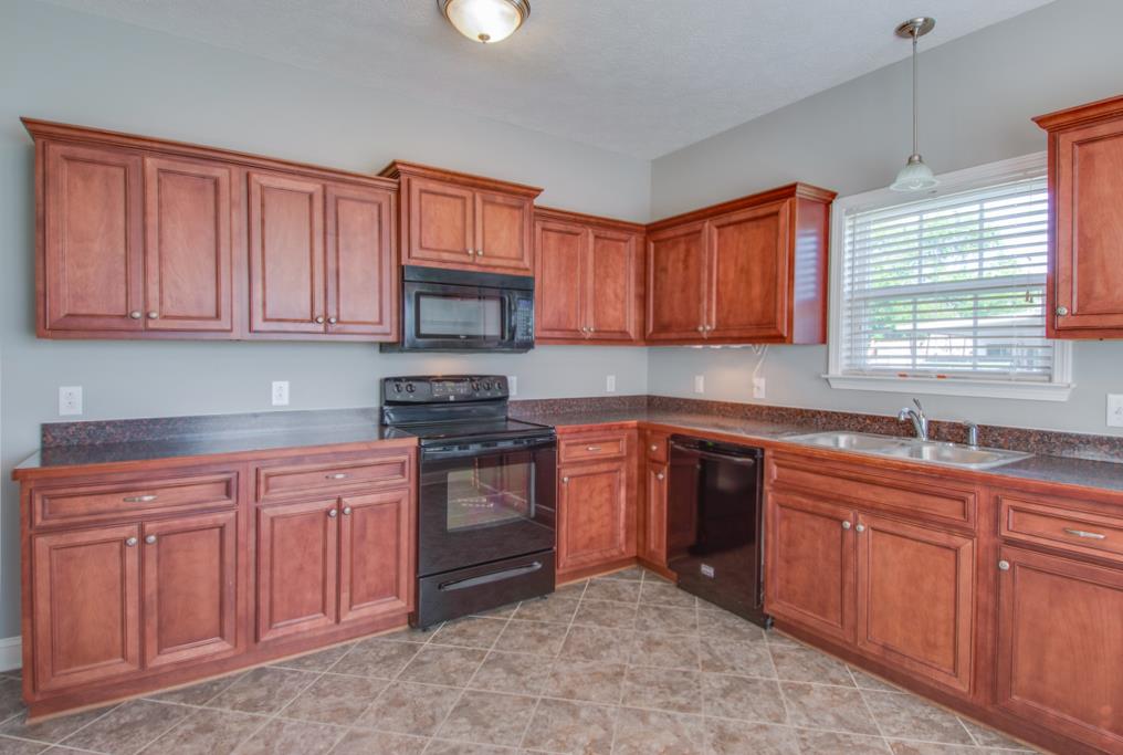 583 Neelys Bend Road Madison, TN 37115 - Photo 11 of 23 The kitchen opens to the living room and features an eat-in area, tile floors and tons of cabinetry!