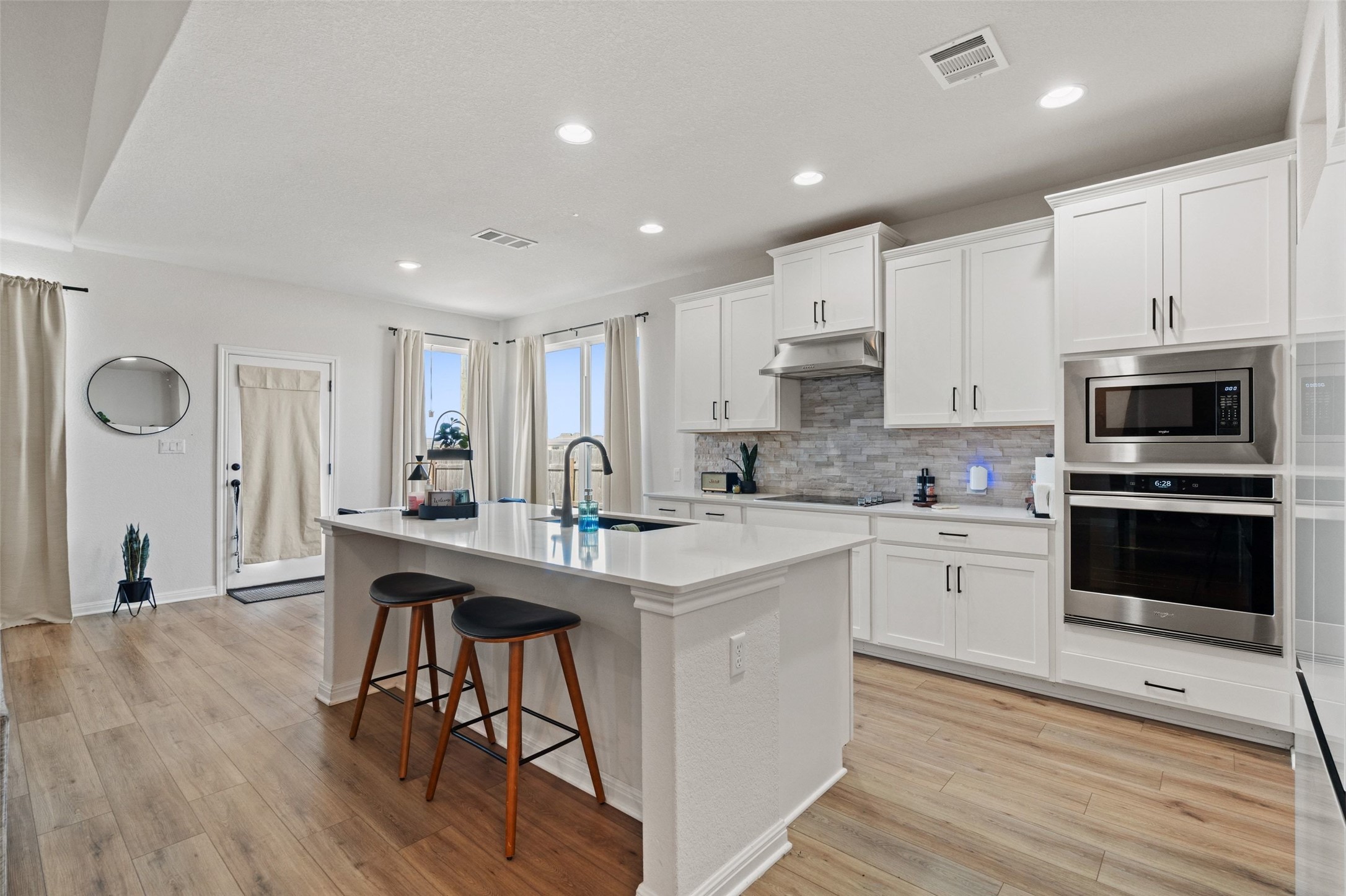 100 Panico Road Hutto, TX 78634 - Photo 7 of 28 A well-appointed kitchen features a large island and contemporary stainless steel appliances, perfect for culinary endeavors.