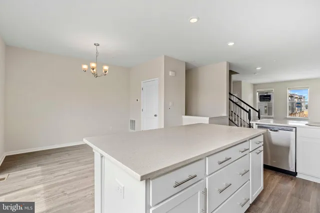 a view of kitchen with cabinets and wooden floor