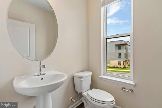 a bathroom with a sink a mirror and a toilet