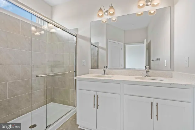 a bathroom with a shower sink and mirror