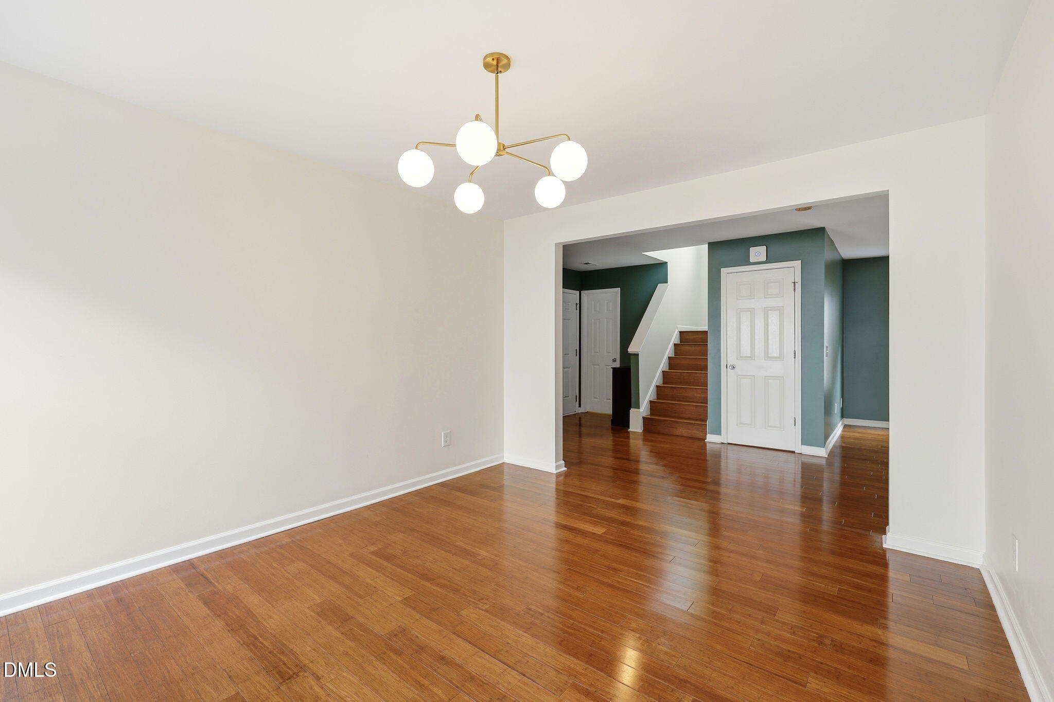 4232 Dalcross Road Raleigh, NC 27610 - Photo 16 of 42 a view of an empty room with wooden floor