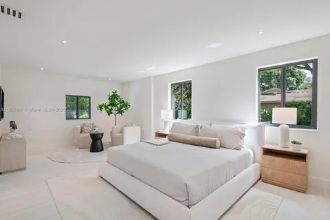 a bedroom with a bed and a large mirror