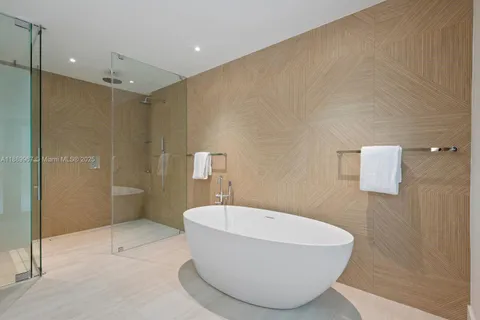 a bathroom with a bathtub sink and mirror