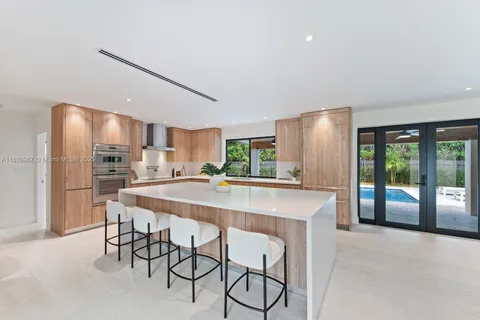a large kitchen with a table and chairs