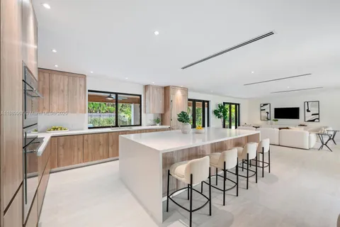 a large kitchen with a table and chairs